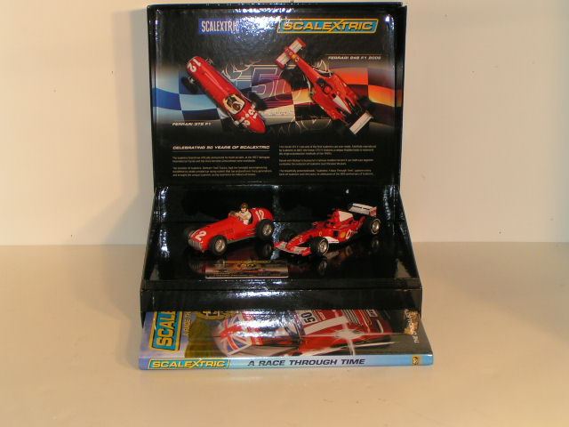 1/32 SET CELEBRATING 50 YEARS OF SCALEXTRIC.HAS 2 F1 CARS & A 50TH ANNIVERSARY BOOK.