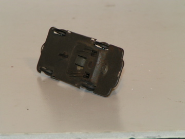 A VIEW OF THE BOTTOM OF THE CHASSIS OF THE POBIEDA SHOWING THE WIDE RUBBER DRIVE WHEEL,THE PIN GUIDE,& THE WIRE CONTACTS.