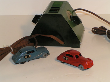 TWO CARS PLUS THE TRANSFORMER WITH CONTROLS ON EACH SIDE FOR EACH LANE.