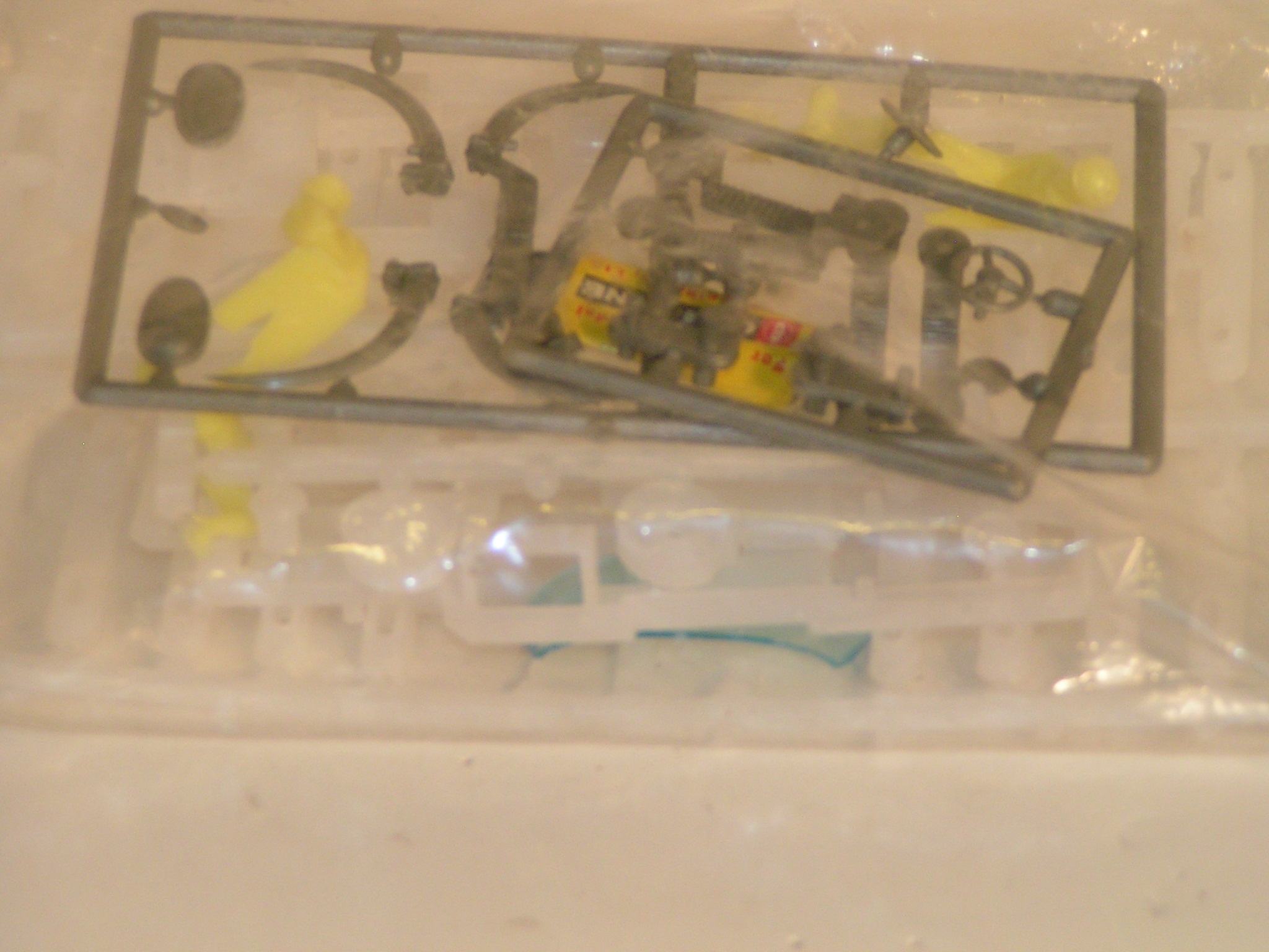 2ND SET-BAG WITH 2 CHASSIS,DRIVERS,BODY PARTS,& TRACK CLIPS.