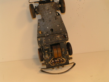 UNDERSIDE SHOWING THE CENTER WHEELS THAT MOVE THE CAR
