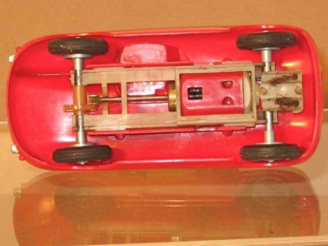 UNDERSIDE OF THE JAGUAR D,1959-60, 6 VOLT RED LONG SHAFT MOTOR,WHITE NYLON CHASSIS & WHEELS . VERY RARE