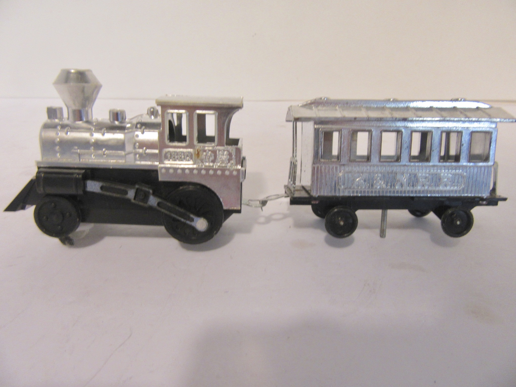 CHROME PLATED TRAIN THAT RUNS ALONG SIDE THE RACE CAR . RARE
