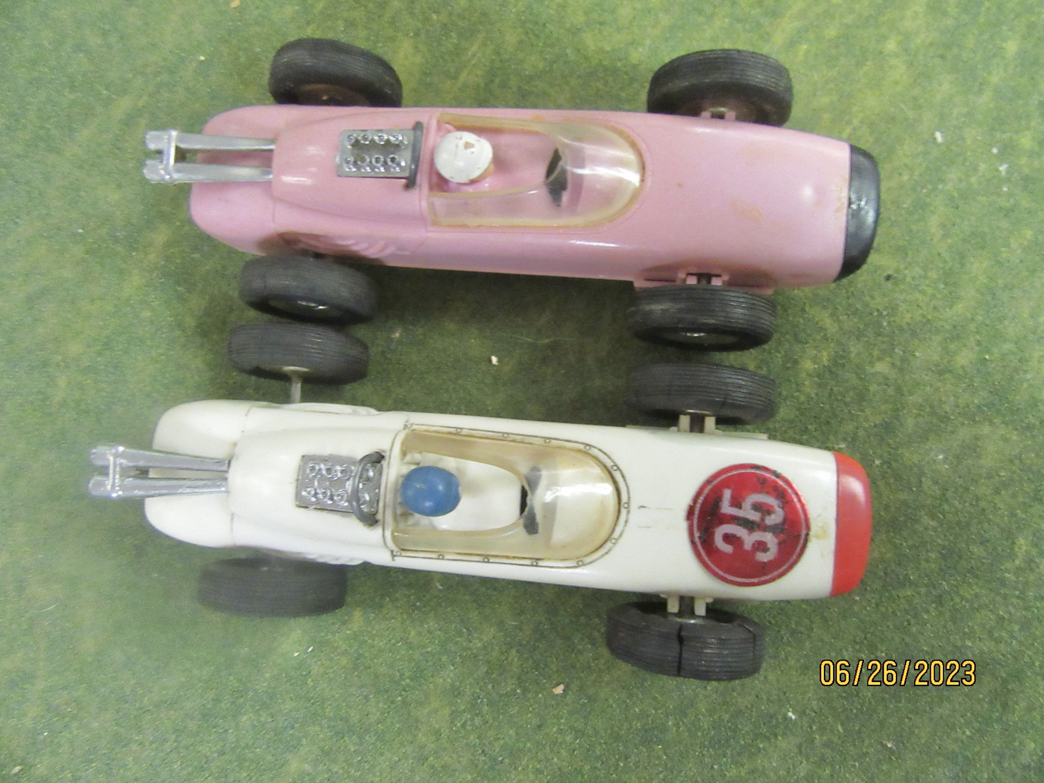 1/30TH SCALE PINK LOTUS 25 NEXT TO A WHITE LOTUS 25 