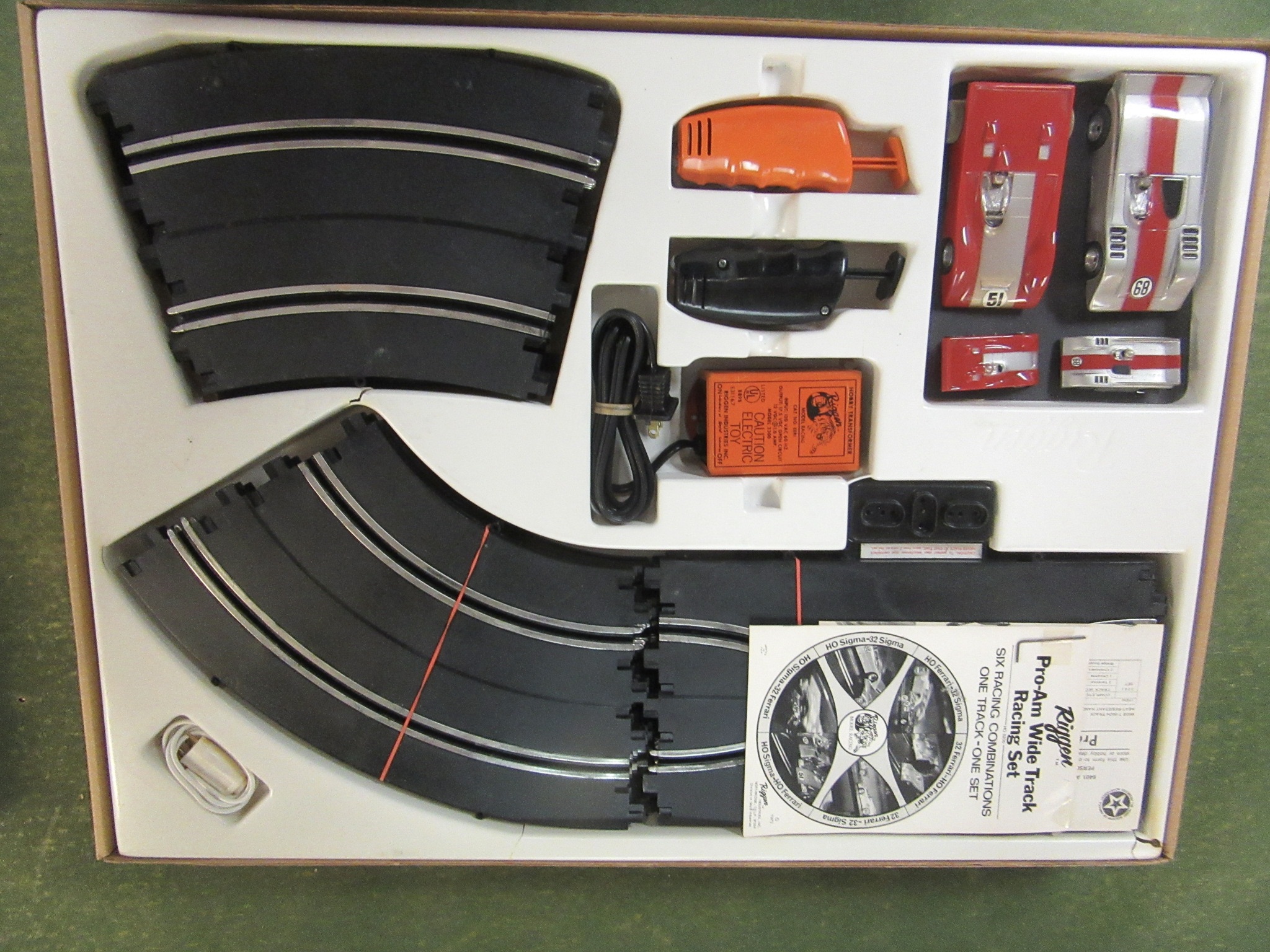  CONTENTS OF THE 1973 SET WITH 2 HO SCALE & 2 1/32ND SCALE CARS WHICH RUN ON THE SAME TRACK. MIB. RARE