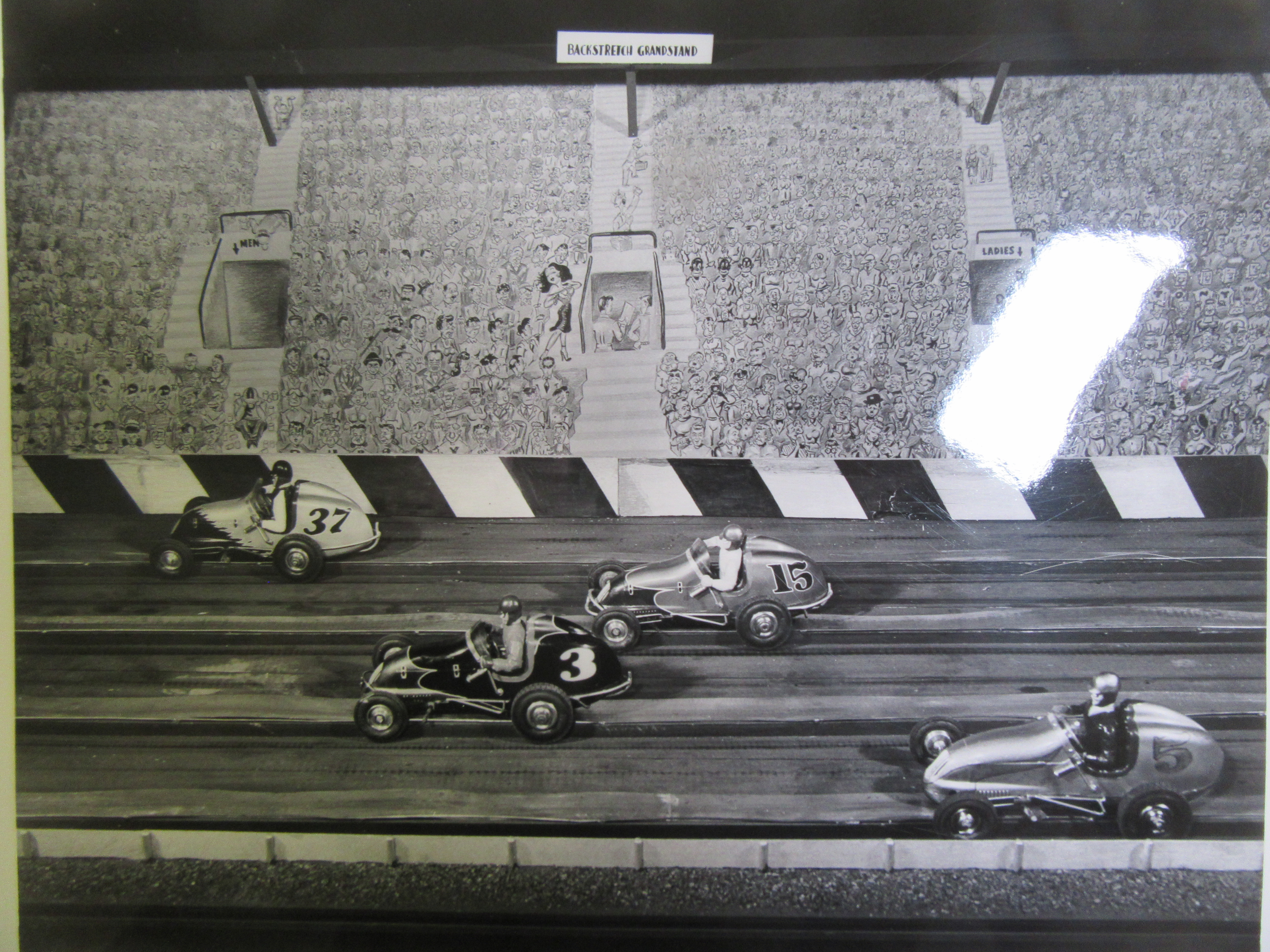 1/18TH SCALE ELECTRIC RAIL CARS ON THE BACK STRETCH . THE GRAND STAND IS HAND PAINTED 
