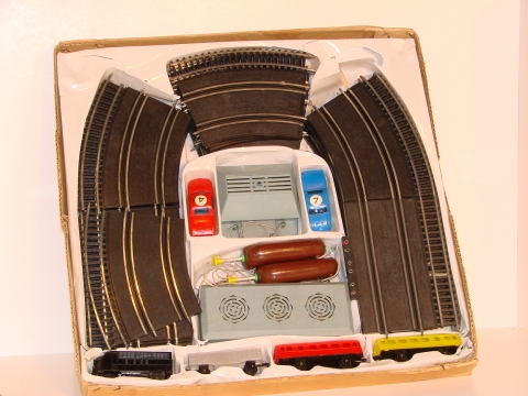 1/43 SET SHOWING THE TRAIN TRACK ON THE OUTER LANE OF THE SLOT TRACK.