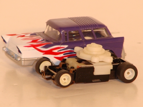 HO SCALE CHEVY WAGON CHASSIS WHICH EJECTS THE BODY WHEN HIT.